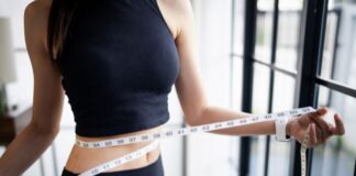 When Weight Loss Becomes Your Personality: Untangling Identity From Eating Disorders Woman With An Eating Disorder Measuring Weight Loss
