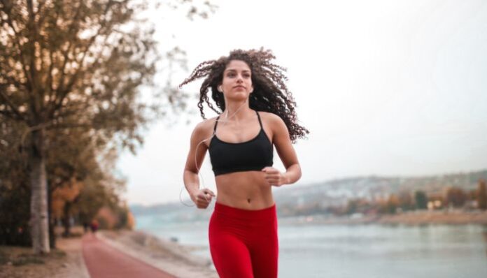 Woman Running Lovely Lady With Curly Hair Out for a Morning Jog Training for Running