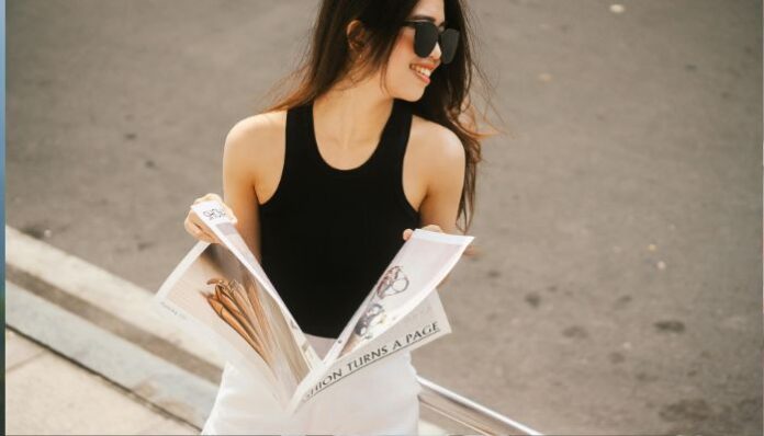 Woman Reading Magazine While Walking