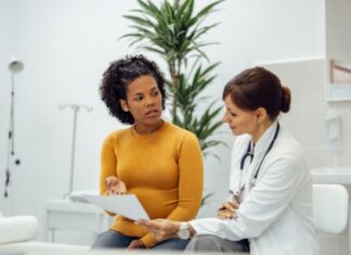 Differences Between State & Federal Malpractice Rules You Should Know Woman Talking to Doctor Who Made Malpractice Mistake