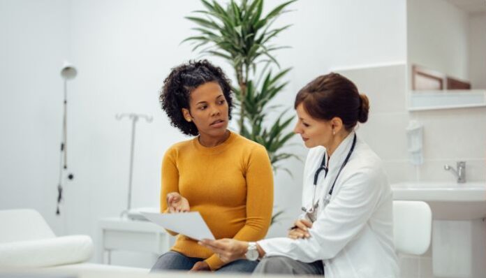 Medical Malpractice Woman Talking to Doctor Who Made Malpractice Mistake