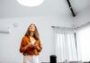 Woman Controlling Lights in Kitchen
