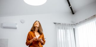 Woman Controlling Lights in Kitchen