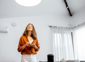 Woman Controlling Lights in Kitchen