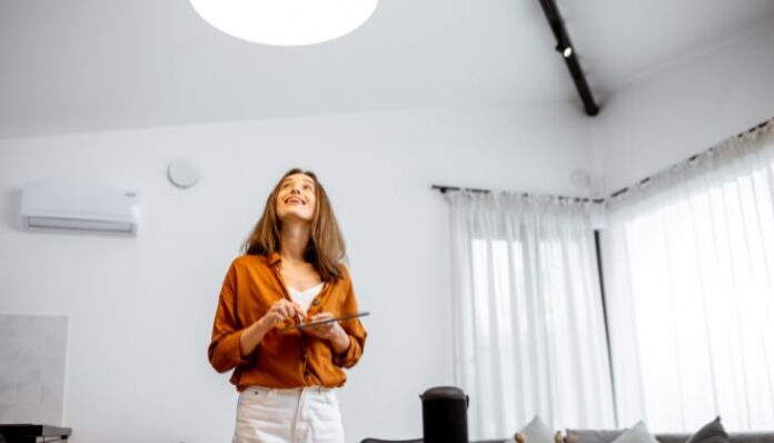 Minimalism and Lighting Woman Controlling Lights in Kitchen