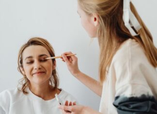 These Beauty Trends Will Make You Feel Effortlessly Gorgeous Woman Applying Makeup