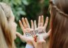 Best Friends Writing on Each Other's Hands in Color Ink