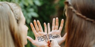 Best Friends Writing on Each Other's Hands in Color Ink