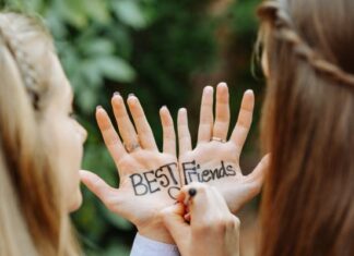 Best Friends Writing on Each Other's Hands in Color Ink