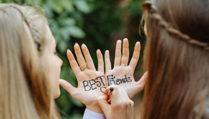 Best Friends Best Friends Writing on Each Other's Hands in Color Ink