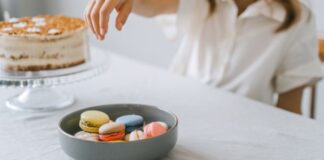 Person Eating Colorful Macarons