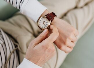 How To Choose A Timeless Luxury Watch That Lasts Man Adjusting Time on Luxury Watch