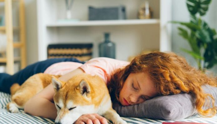 Sleep Disruption Woman Sleeping With Dog and Having Sleep Disruption