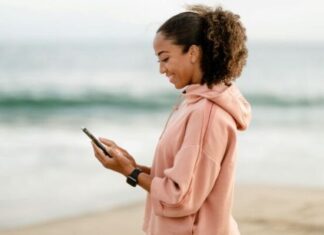 Why Small Creators Are Seeing Bigger Results Than Influencers Right Now woman on Tiktok on phone smiling