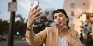 Woman Blowing Kiss on Video Call With Friend to Celebrate Special Day Long Distance