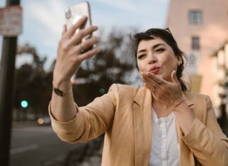Woman Blowing Kiss on Video Call With Friend to Celebrate Special Day Long Distance