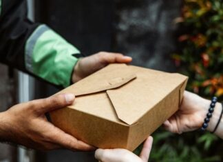 The Night I Realized Takeout Isn’t Just About Food Person in green and black jacket delivering takeout food to woman who didn't have energy to cook