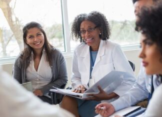 How Specialized Programs Support Healthcare Workforce Needs Group of Healthcare Workers Meeting With Specialist