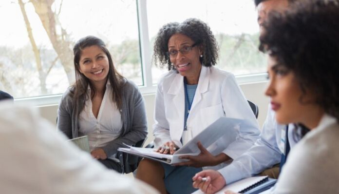 Group of Healthcare Workers Meeting With Specialist