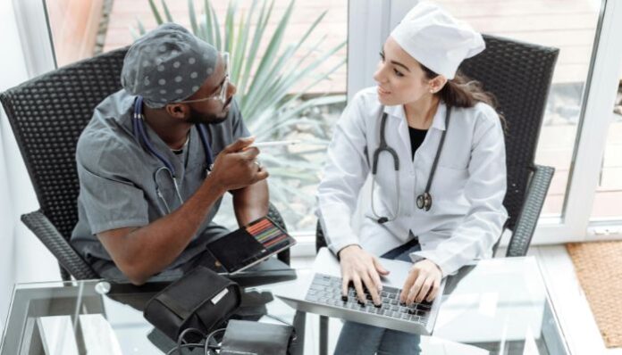 Two doctors talking through treatment plan for personalized medical care
