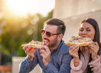 Delicious Moments That Make Travel More Thrilling Couple eating Pizza While Traveling