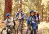 Mixed Race Family Riding Bikes in California Forest