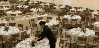 Woman wearing all black setting up event
