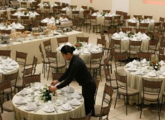 Why Professional Event Rentals Save Time & Reduce Stress Woman wearing all black setting up event