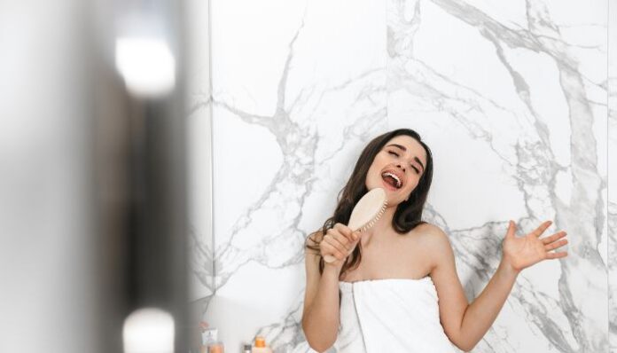 Woman in Bathroom Woman Singing in Bathroom With White Tile Wall