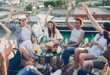 Engaging Office Event Ideas That Your Employees Will Love Group of young coworkers celebrating with after hours event