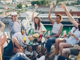 Engaging Office Event Ideas That Your Employees Will Love Group of young coworkers celebrating with after hours event