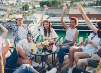 Office Event Ideas That Your Employees Will Actually Enjoy Group of young coworkers celebrating with after hours event