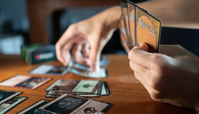 Magic The Gathering Cards Person Playing Magic The Gathering at a Wooden Table