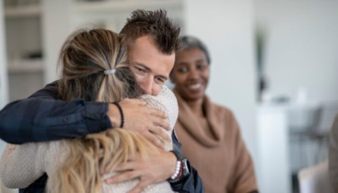 Man and Woman Embracing After Addiction Treatment