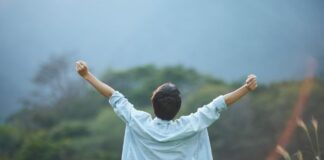 Person Celebrating Growth and Accomplishment Outdoors