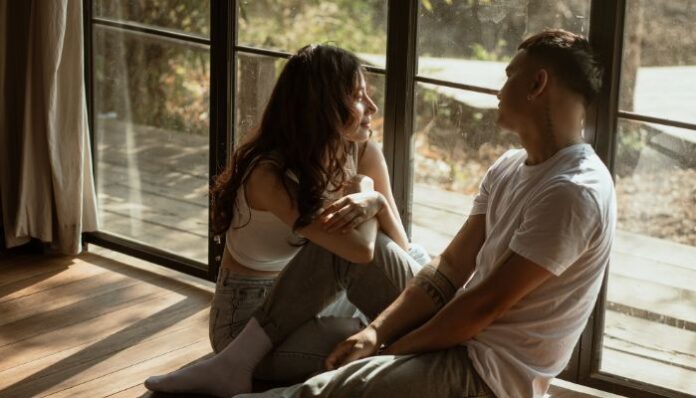 Talk About Kinks Couple sitting near a window in their home, talking about their personal bedroom kinks