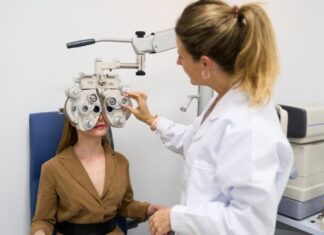 Female Optometrist giving a young woman an eye exam to test for vision problems