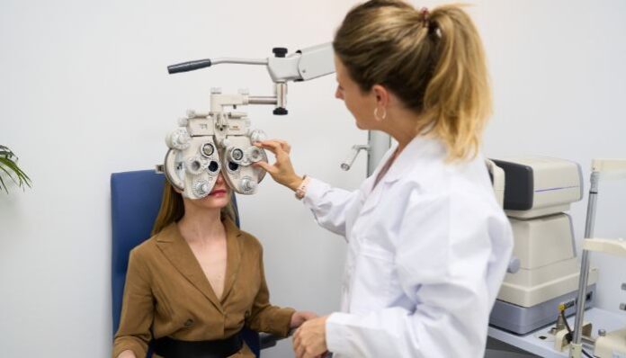 Vision Problems Female Optometrist giving a young woman an eye exam to test for vision problems