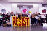 RESIST_sign_at_SFO_-noban_Protest_-Jan_29,_2017_(32564563276)