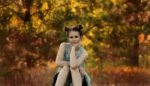 girl-sitting-posing-trees